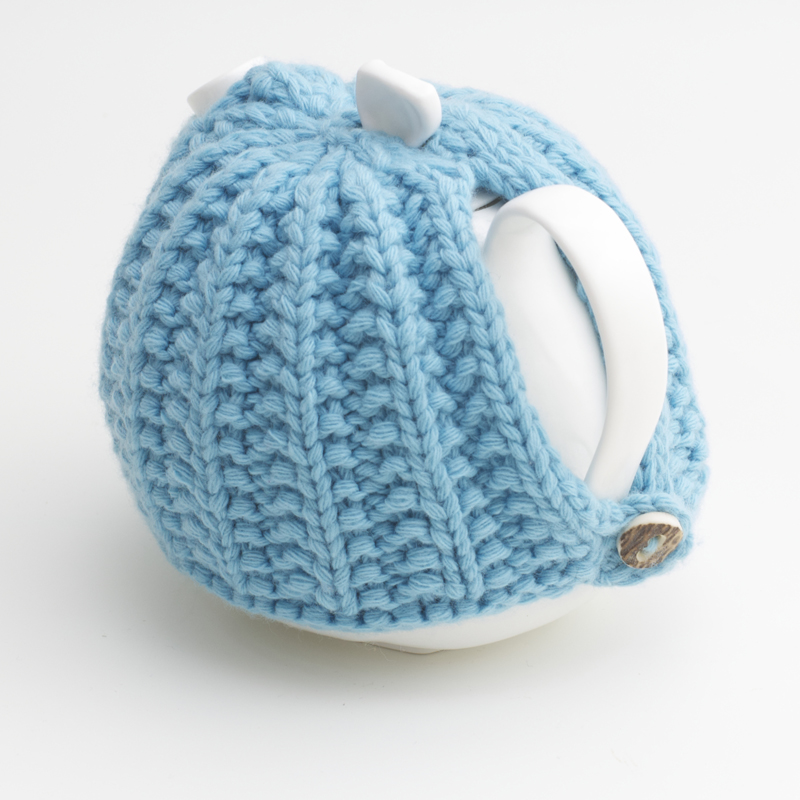 Bone China Teapot designed by Linda Bloomfield, with blue knitted cosy by Ruth Cross